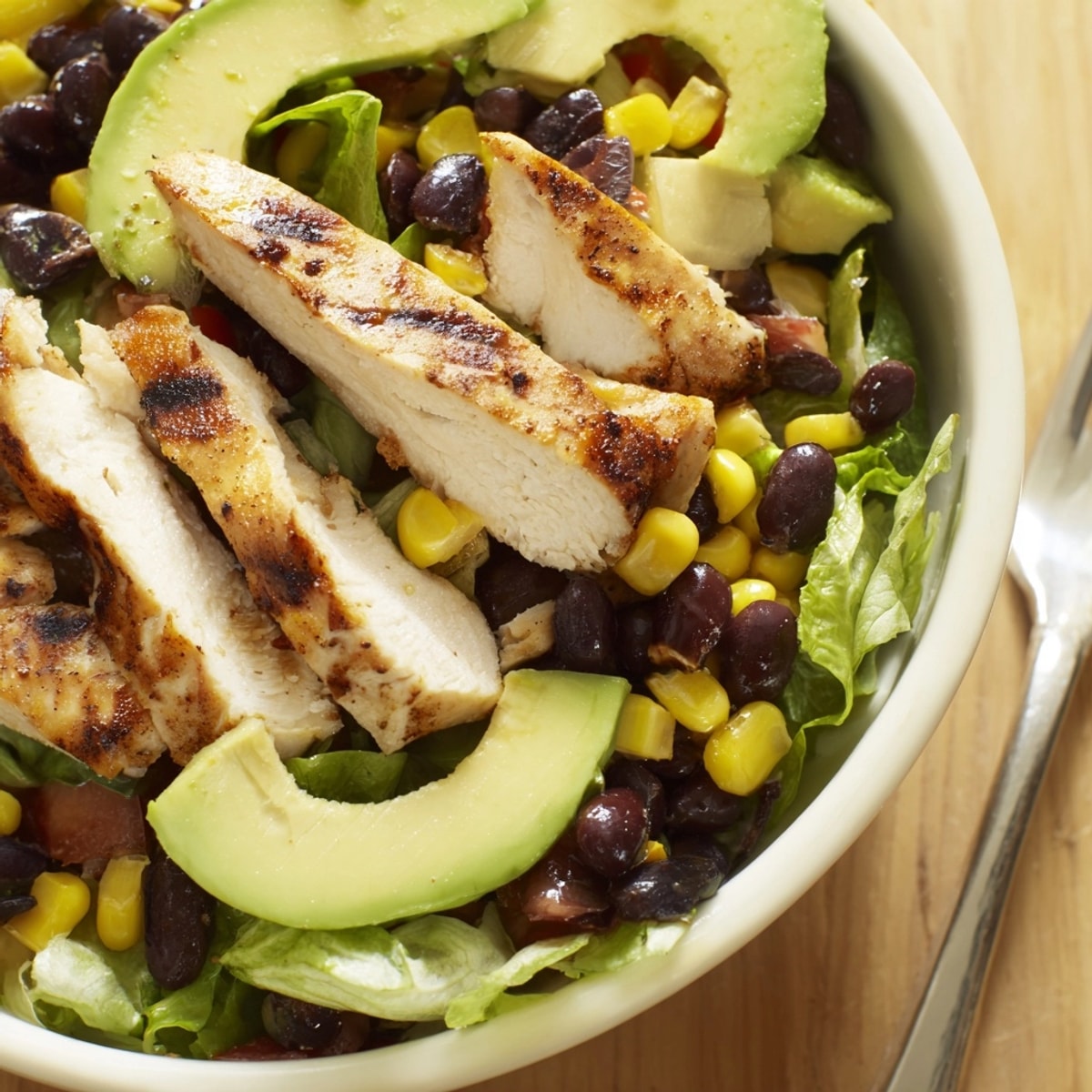 Southwest chicken salad bowl: Grilled chicken and creamy avocado over crisp lettuce.