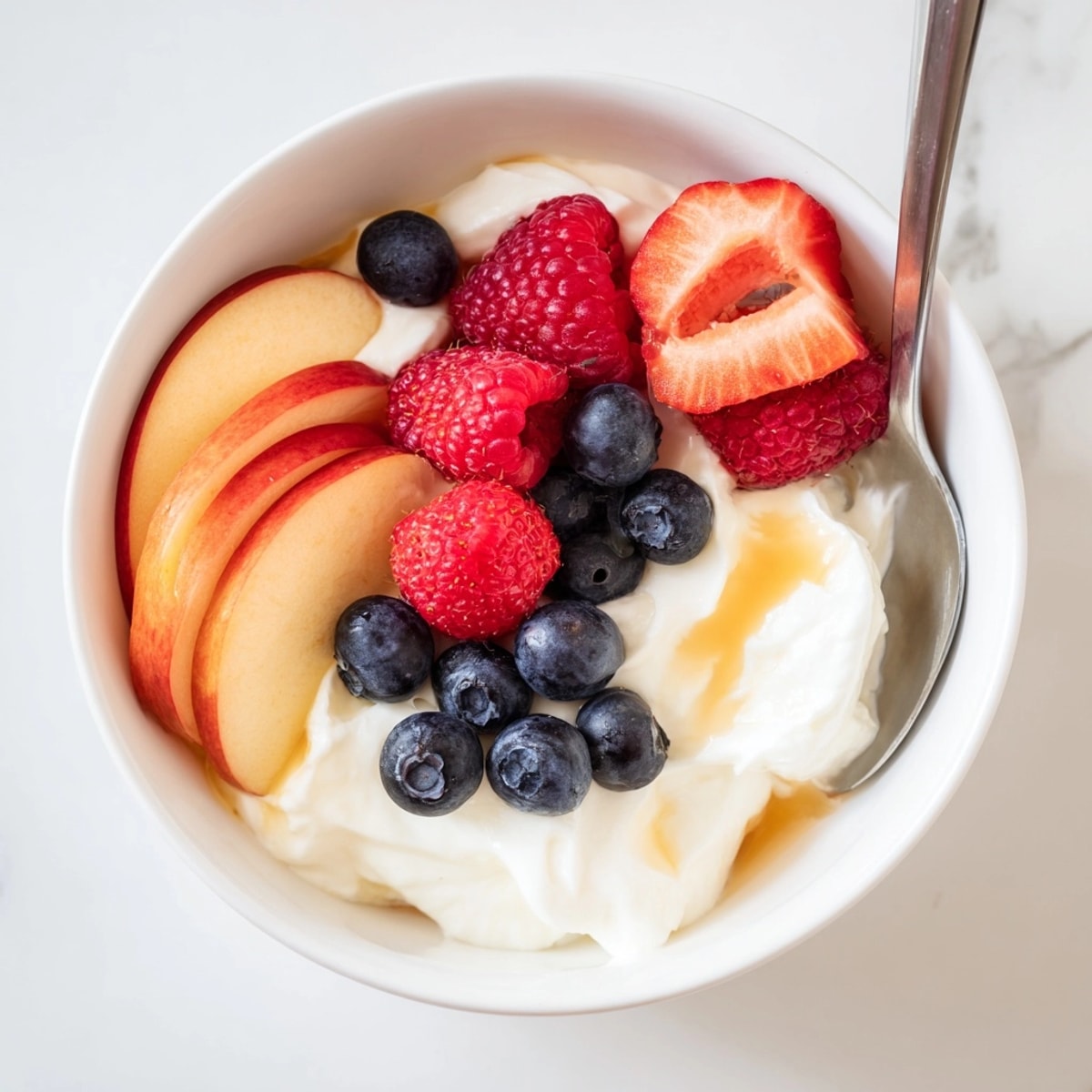 Creamy Greek Yogurt Fruit Dip glistening; perfect healthy snack for dipping strawberries and grapes.