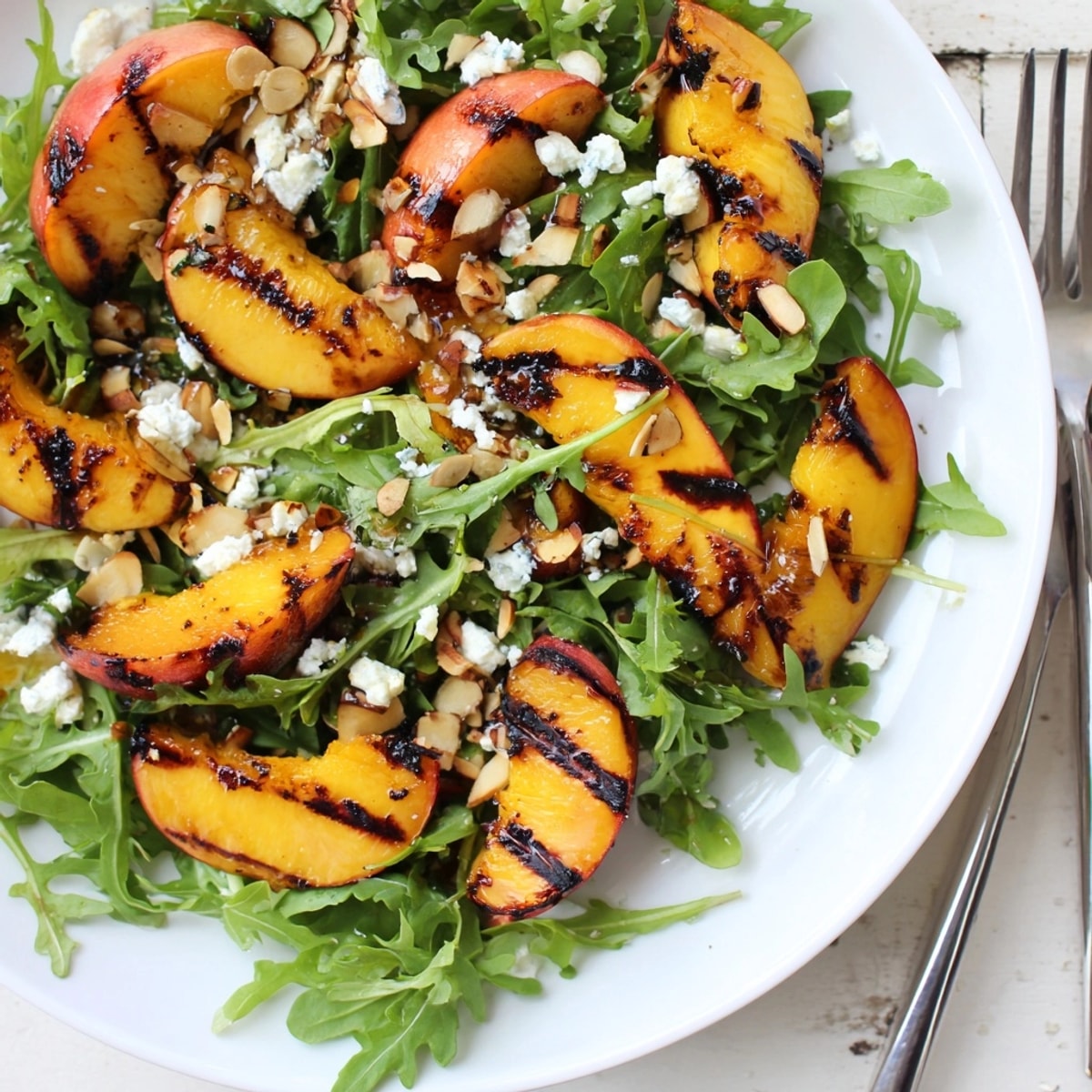 Grilled Peach & Arugula Salad: smoky grilled peaches paired with peppery arugula and creamy goat cheese.