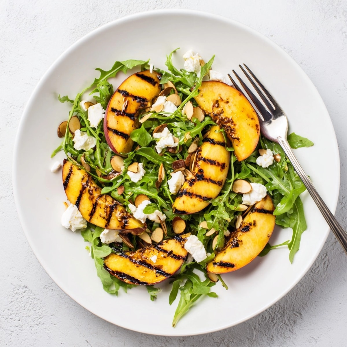 Making Grilled Peach & Arugula Salad: juicy peaches char on the grill, ready to serve.