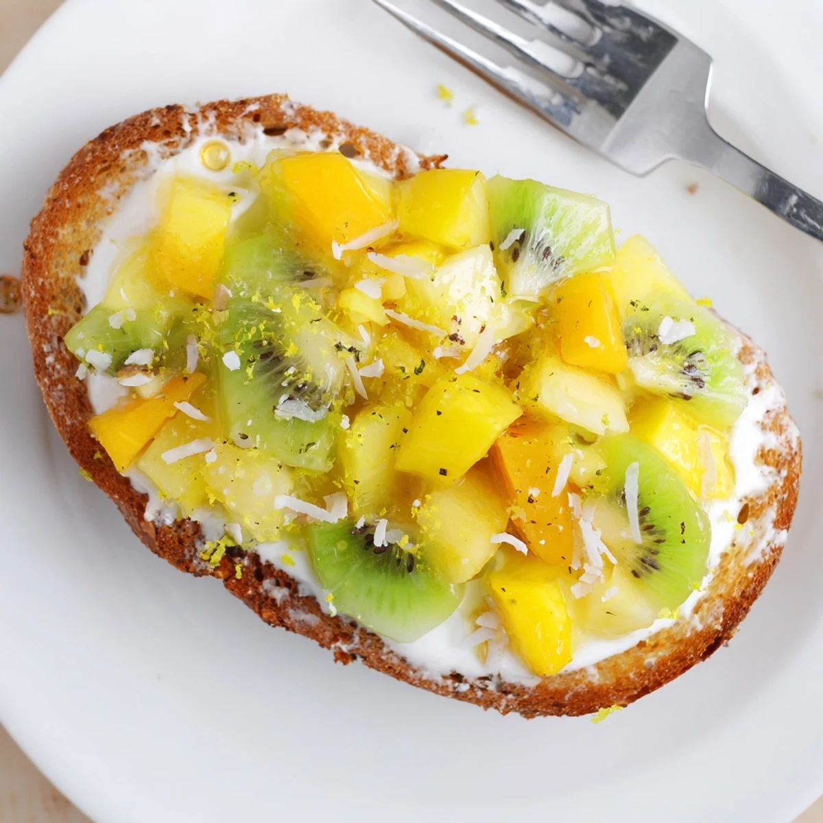 Creamy yogurt-custard toast topped with tropical fruits, perfect for brunch delight.  