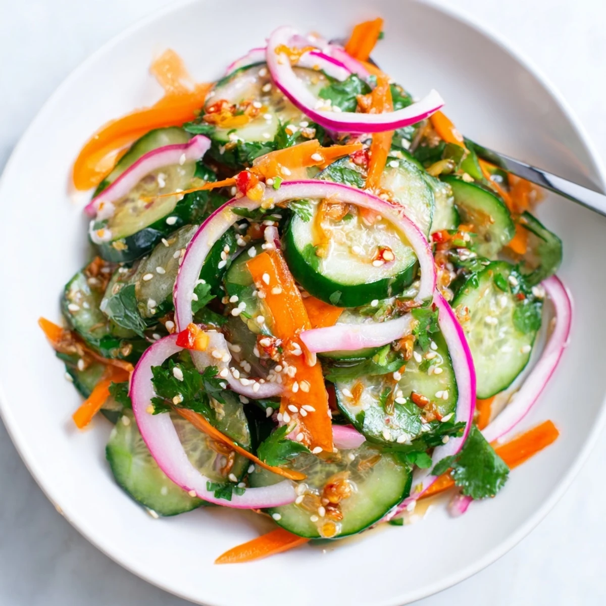 Savory Cucumber Salad Remix featuring sliced vegetables and a tangy Asian dressing.  