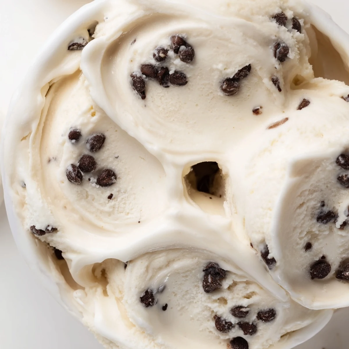 Creamy cottage cheese ice cream adorned with chocolate chip cookie dough chunks.  