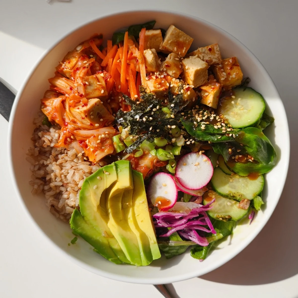 A colorful fermented vegetable bowl with tangy kimchi, fresh greens, and grains.  