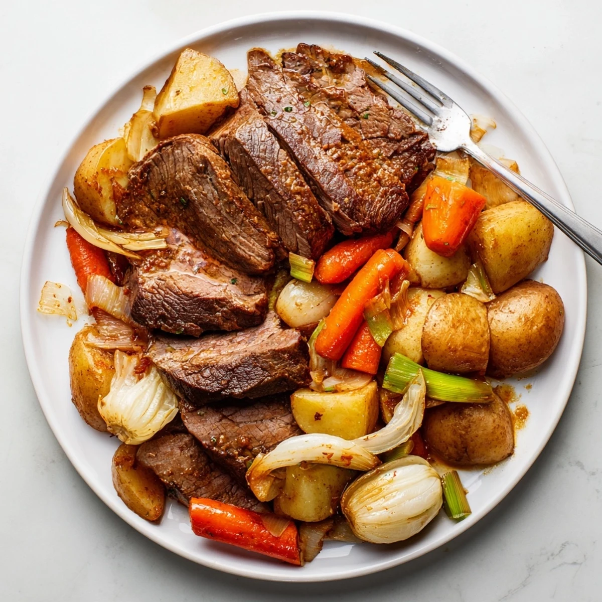 Tender Sunday Pot Roast surrounded by vibrant roasted carrots, potatoes, and cozy spices.  