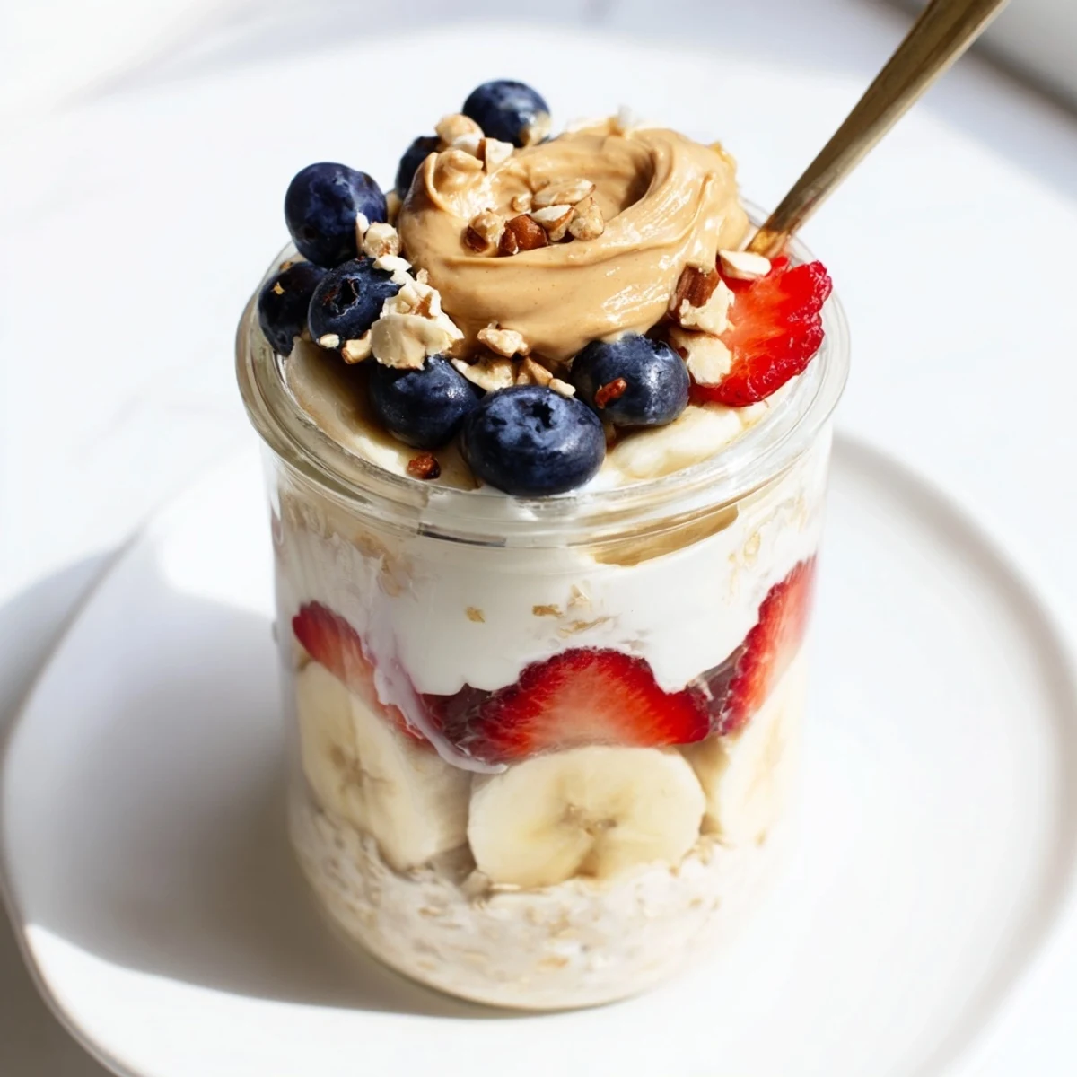 Perfectly chilled Overnight Oats Jars, bursting with fresh berries and drizzled with peanut butter deliciousness.