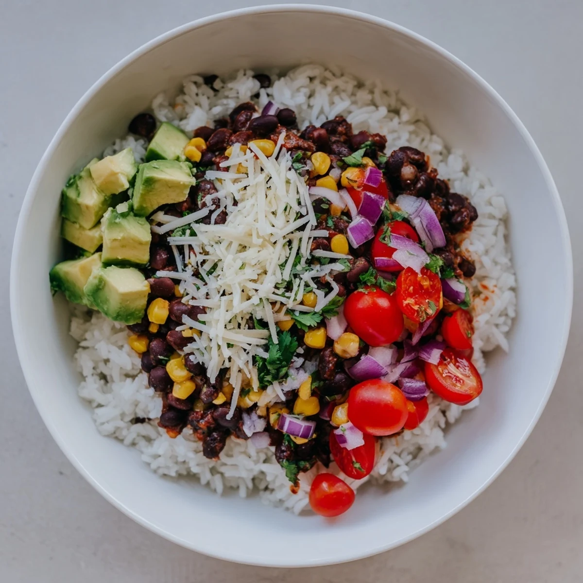 Fluffy rice, seasoned beans, and vibrant corn create a delicious Rice, Bean, and Corn Burrito Bowl meal.