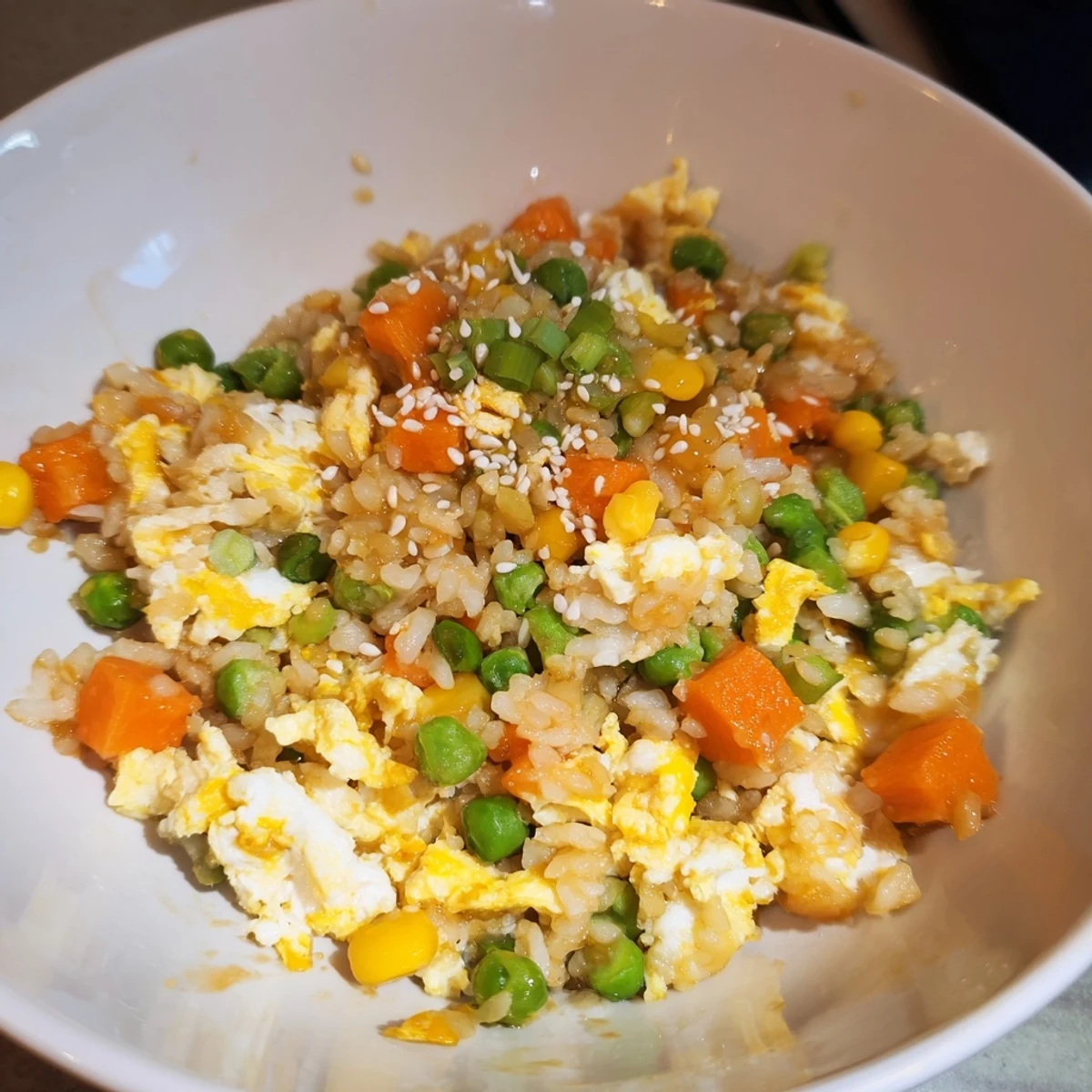 Steaming hot Frozen Veggie Fried Rice with fluffy scrambled eggs and a glossy soy sauce finish.