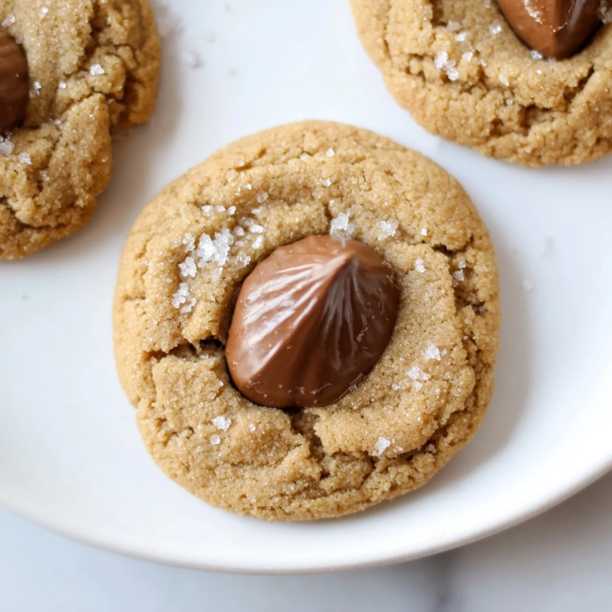 Freshly baked 3-Ingredient Peanut Butter Blossoms, with melted chocolate kiss topping, appealing aroma.
