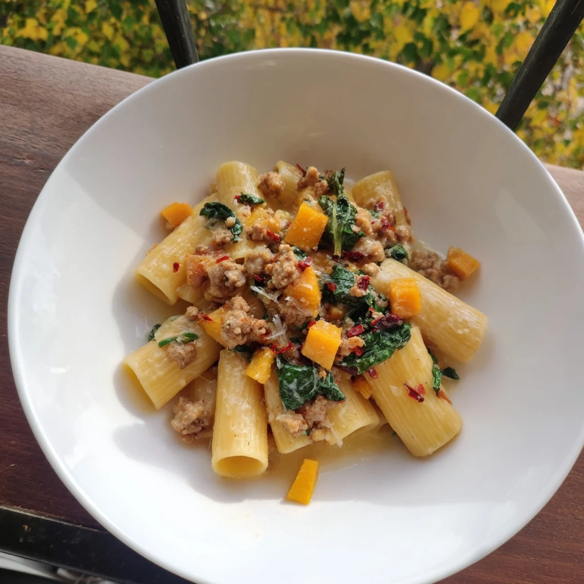 Picture a close-up of delicious Creamy Rigatoni with Butternut Squash, ready to enjoy with a glass of wine.