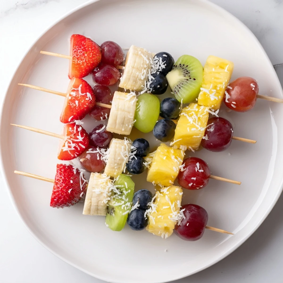 Vibrant Easy Festive Fruit Kabobs, ready to eat, with bright red strawberries and green grapes threaded.