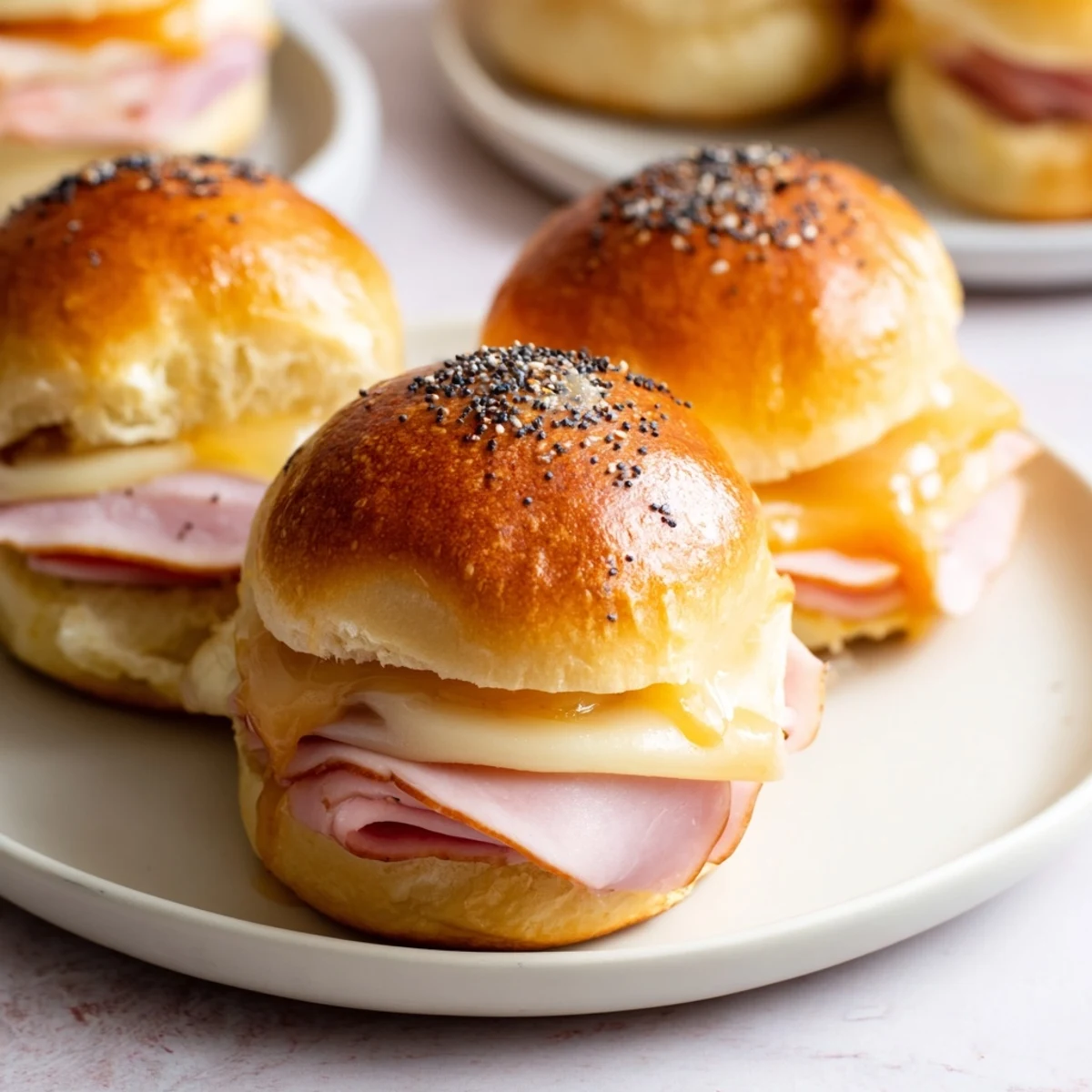 Warm and cheesy Budget-Friendly Ham & Cheese Sliders fresh from the oven, perfect for sharing.