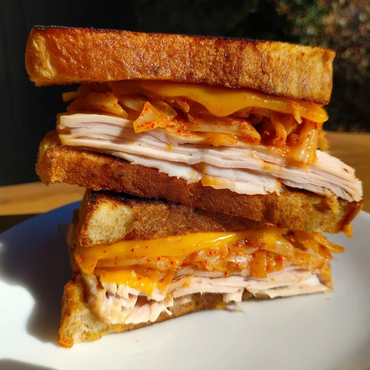 Golden, melty Kimchi Turkey & Cheddar grilled cheese sandwich on toasted sourdough, ready to enjoy.