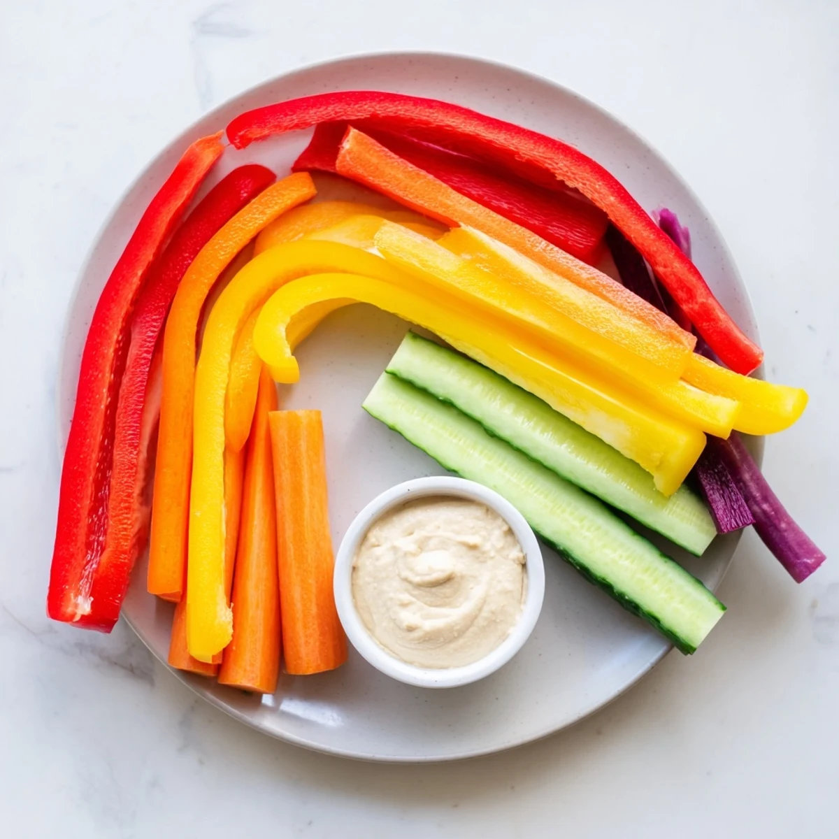Vibrant rainbow arch veggie sticks, a healthy and colorful snack perfect for dipping and sharing.
