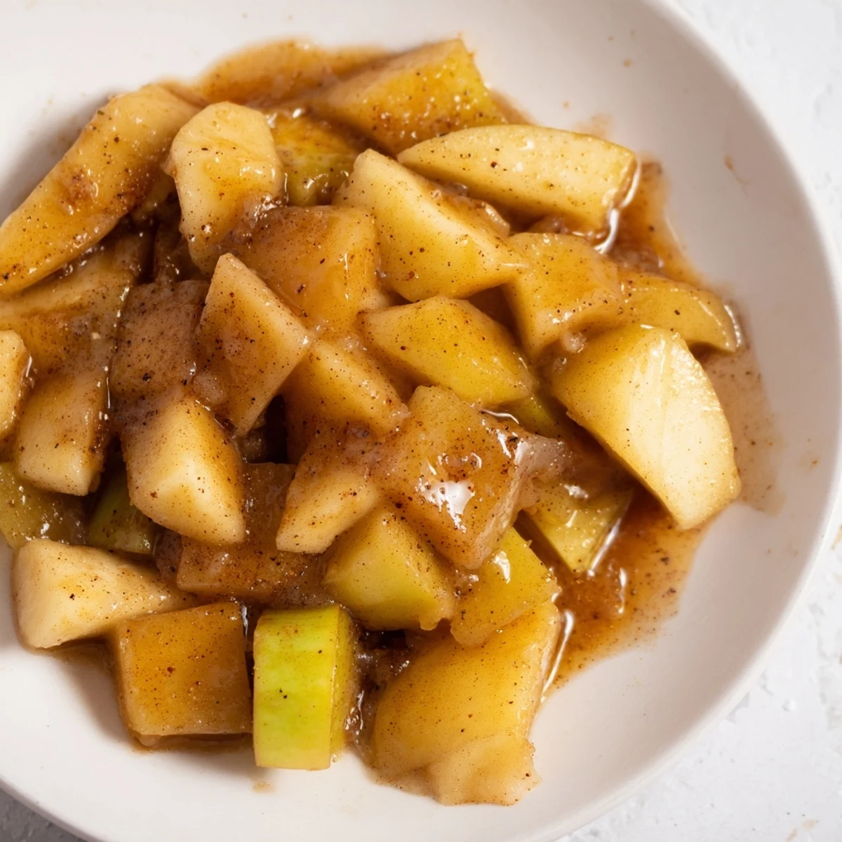 Golden, glistening Slow Cooker Stewed Apples simmered to tender perfection with warm cinnamon spices.