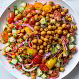 A bright bowl of BBQ Chickpea Salad with colorful vegetables, perfect for a picnic treat.