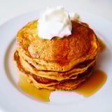 A warm stack of fluffy pumpkin spice pancakes, fragrant with cinnamon, perfect for a fall breakfast.