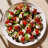 Golden Zucchini Caprese Bites, featuring fresh tomatoes and basil, are a simple and flavorful Italian appetizer.
