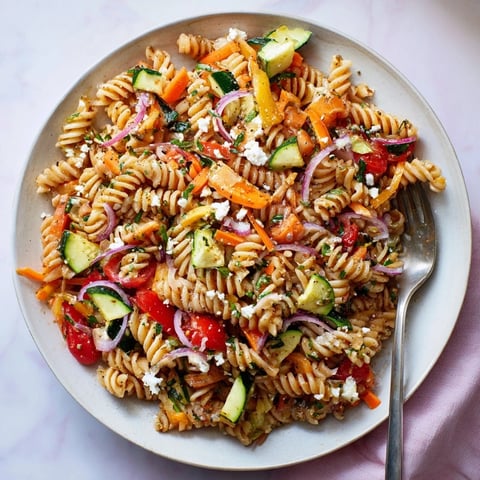 Bright, colorful Pasta Salad with Seasonal Veggies ready to serve, featuring a zesty dressing.