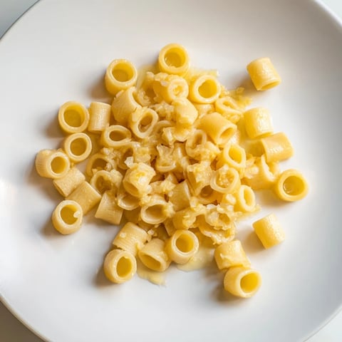 Golden butter coating the ditalini pasta, tossed with fragrant garlic for pure comfort.