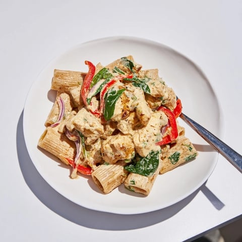 Creamy Cajun Dirty Snow Chicken Pasta, steaming hot, filled with bell peppers and tender chicken.