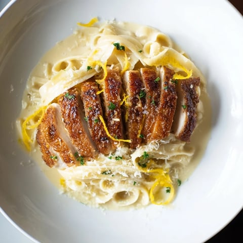 Golden, caramelized Lemon Brûlée Chicken atop creamy pasta, a delicious homemade recipe.