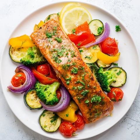 Golden-brown salmon sheet pan bake with colorful roasted vegetables ready to serve and enjoy.