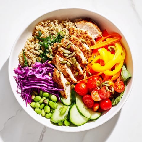 Colorful layers of Healthy Meal-Prep Bowls featuring quinoa, fresh veggies, and zesty dressing.  