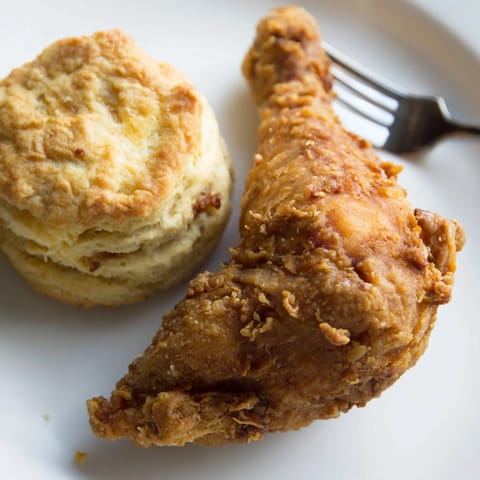 Golden, juicy Southern fried chicken alongside freshly baked buttermilk biscuits.  