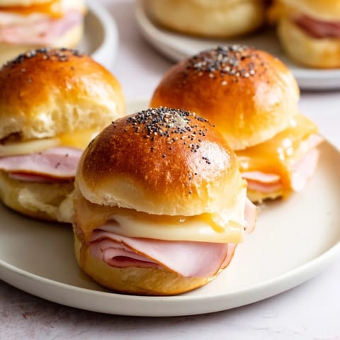 Warm and cheesy Budget-Friendly Ham & Cheese Sliders fresh from the oven, perfect for sharing.