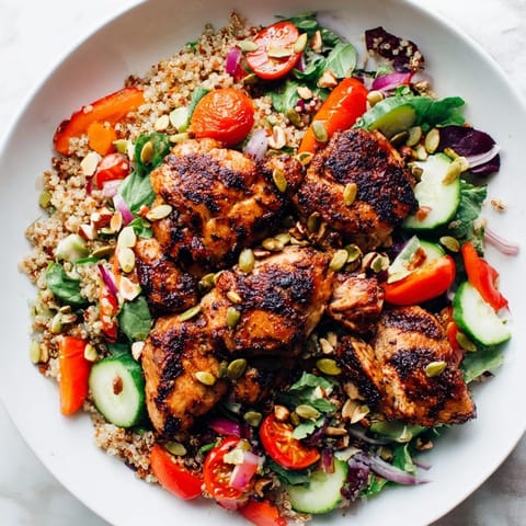 A refreshing bowl of Crunchy Quinoa Chicken Salad with toasted nuts and fresh herbs for added flavor.