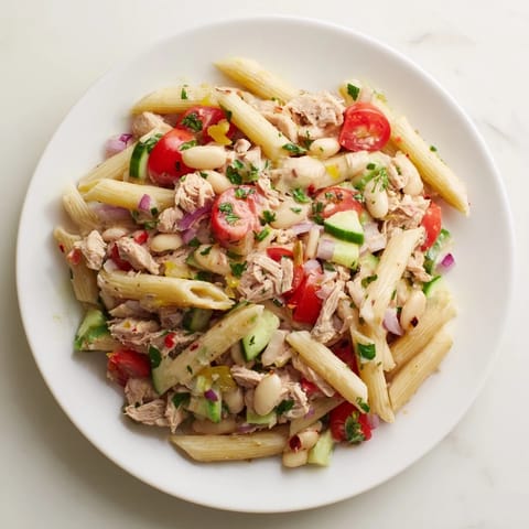 Flaky tuna and creamy beans mingle in this Spicy Tuna and White Bean Pasta Salad recipe.