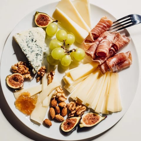 Elegantly arranged Wine & Food Pairing Platter featuring a colorful array of cheeses, meats, and crackers.