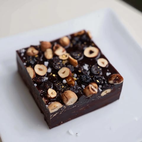 Visually stunning Midnight Mosaic features sliced figs, black olives, and rich dark chocolate layers.