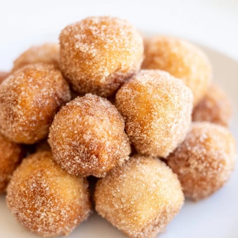 Served warm, these air fryer cinnamon donuts offer a perfect, quick American dessert or snack.