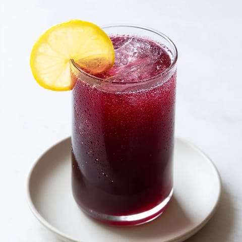 Refreshing Sleepy Girl Mocktail, a vegan bedtime drink, garnished with a bright lemon slice.