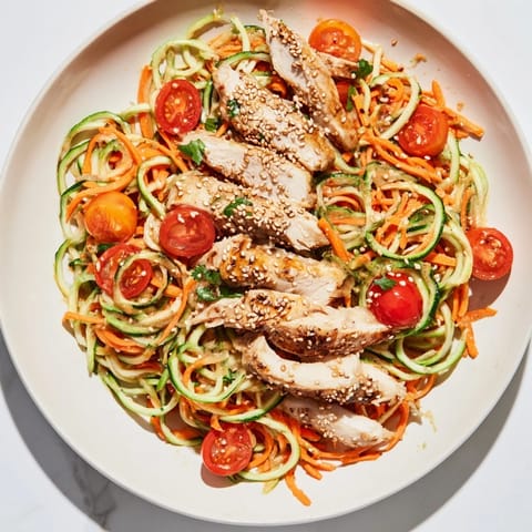 Close-up of a delightful Protein Cucumber Salad with juicy grilled chicken and cucumber spirals.