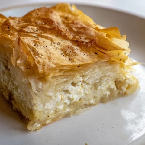 Warm, aromatic Bulgarian Banitsa, baked to a perfect golden brown, ready to be enjoyed.