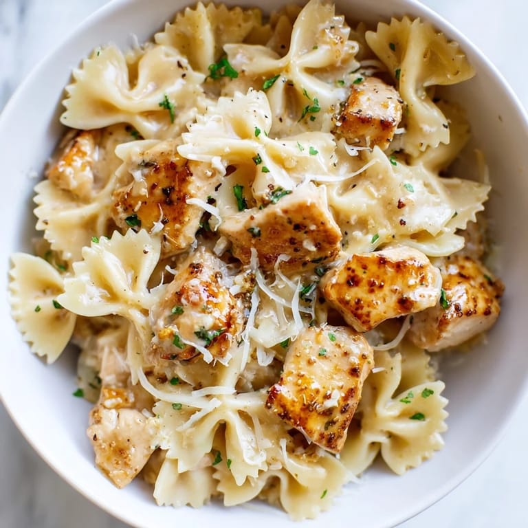Bowtie pasta intermingled with succulent chicken in a rich garlic butter sauce.
