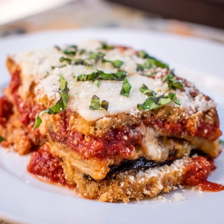 A bubbling 9x13 inch pan of Eggplant Parmesan Lasagna, topped with melted mozzarella and Parmesan cheese.