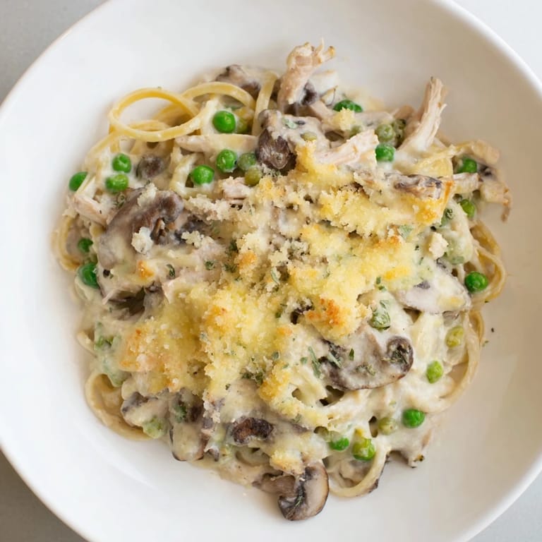 A close-up of creamy Turkey Tetrazzini, showing tender turkey and mushrooms in a rich, flavorful sauce.