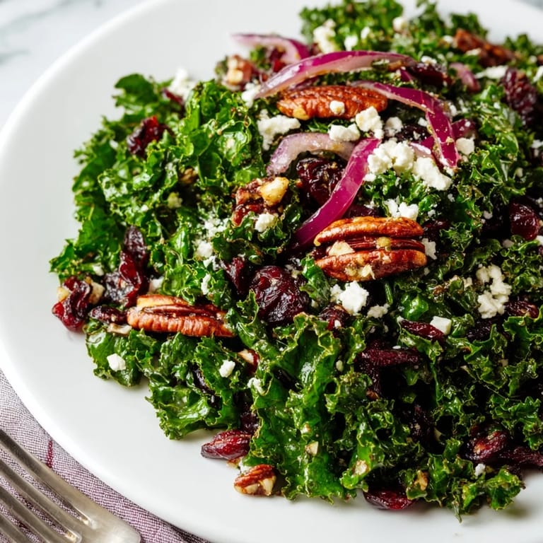 Lush greens coated in a glossy maple mustard dressing, finished with crunchy nuts and cranberries.